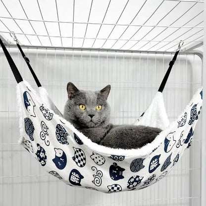 Gato com olhos bem abertos deitado em rede de cadeira suspensa para gatos